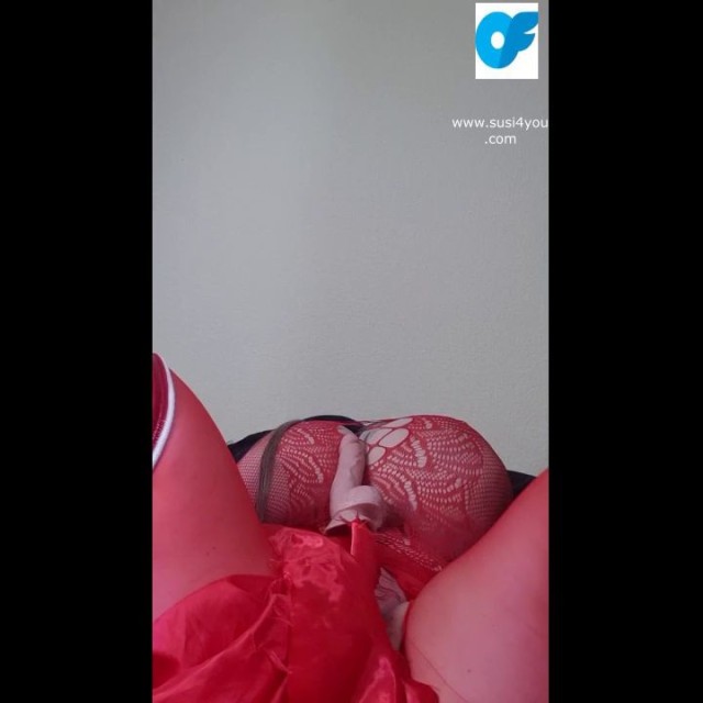 Watch nasty Susi lying on back playing with toy between tits