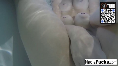A blond lady with hefty titties takes a bath with some rubber duckies in her bathtub